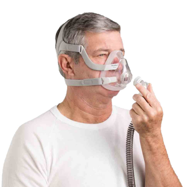 Man Attaching Tubing to F20 Mask